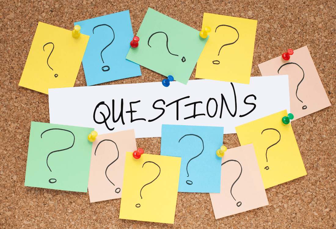 Multiple questions on a pinboard representing the crucial questions to ask a prospective cleaning company.