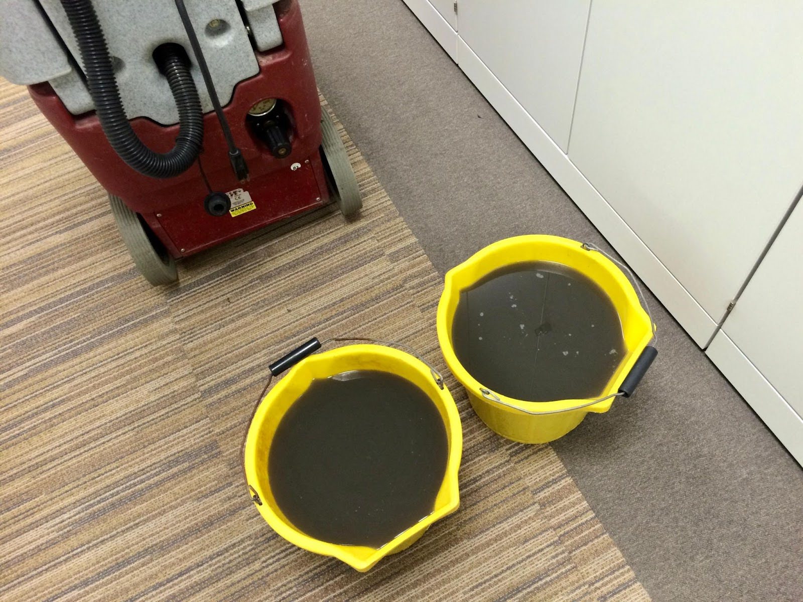 A commercial cleaning contractor deep cleaning an office floor regularly to highlight the importance of a clean work environment.