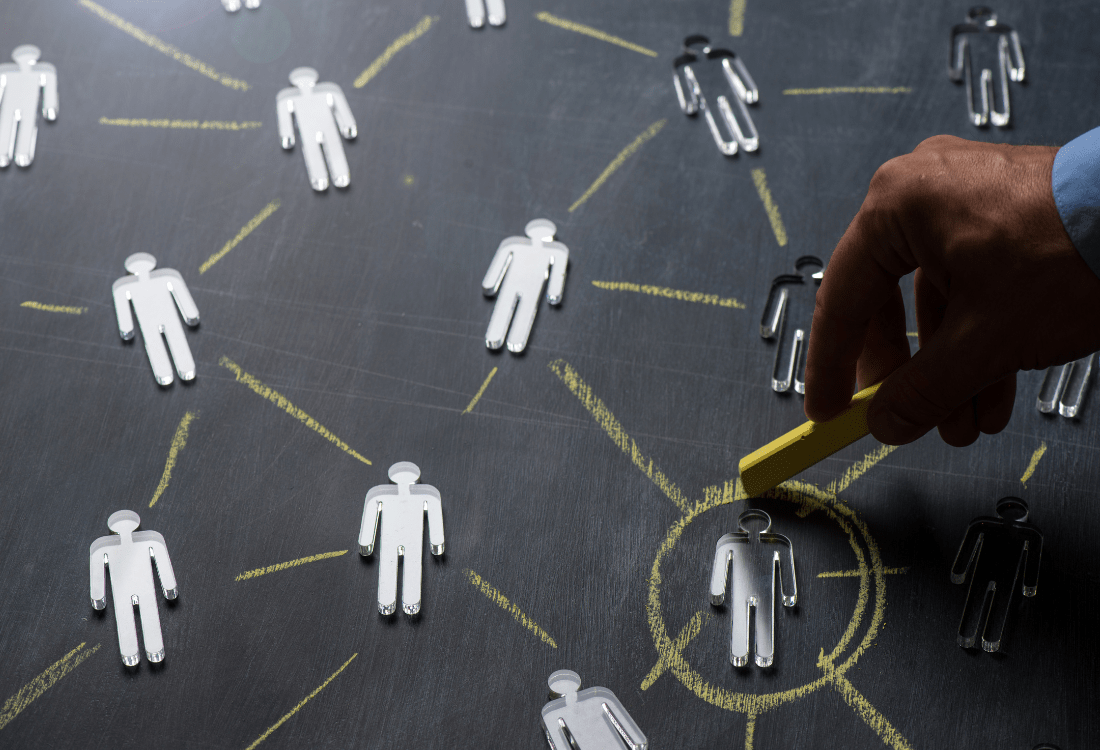 Someone circling a man on a chalkboard, emulating someone who has chosen the right office cleaning contractor for their business.