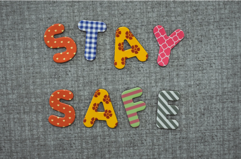 Letters spelling out “stay safe” on a grey carpet to show the importance of choosing the right cleaning company to keep your students safe and healthy in your care.