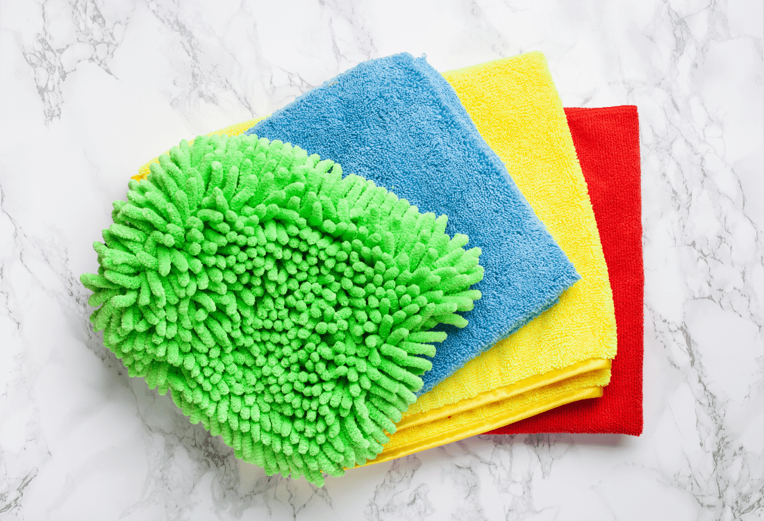 A sponge and multiple multi-coloured cloths are ready to clean the surfaces to stop cross-contamination around the office.